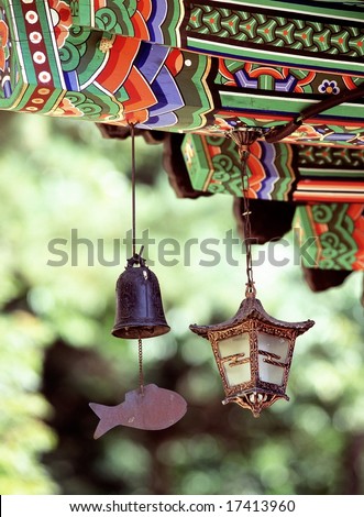 Korean Tradition and Symbol - artistic painted eaves of wooden architecture in Korea background with beautiful trees