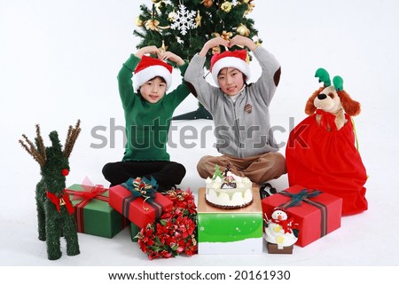 Xmas Lovely Joyful Kids sitting and playing with Christmas gifts, sweet cake, a cute snowman, red flower bouquet and dress a big green tree on white background