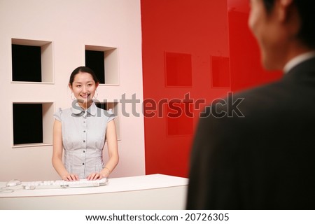 Attractive Asian young Career Woman - beautiful happy smiling with friendly businesspeople on white and red wall background