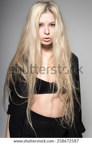 sexy blond fashion model with long hair, young European attractive, beautiful eyes, full lips, perfect skin is posing in studio for glamour test photo shoot showing different model poses