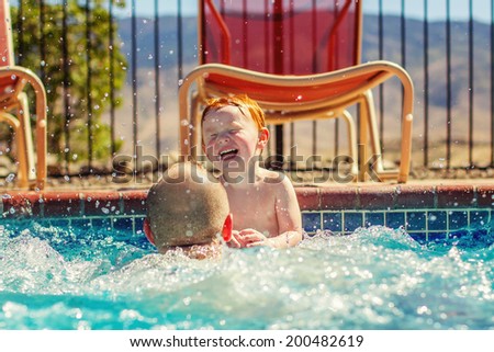 Father playing with his 2 year old son in the pool -- image taken in Reno, Nevada, USA
