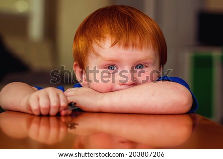 2 year old boy playing at a wooden table -- image taken indoors in Reno, Nevada, USA