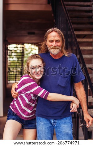 Tween girl hugging her grandfather -- image taken outdoors in Reno, Nevada, USA