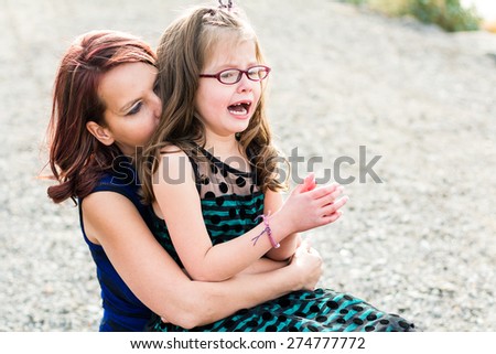 Mother consoling her hurt daughter at a park in Reno, Nevada, USA.