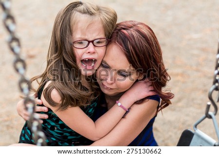 Mother comforting her daughter after getting hurt at a park in Reno, Nevada, USA.