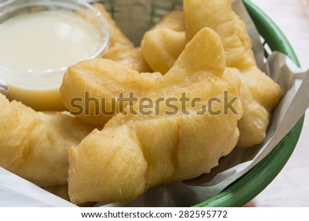 Breakfast in Thailand deep-fried doughstick and milk  background, close-up