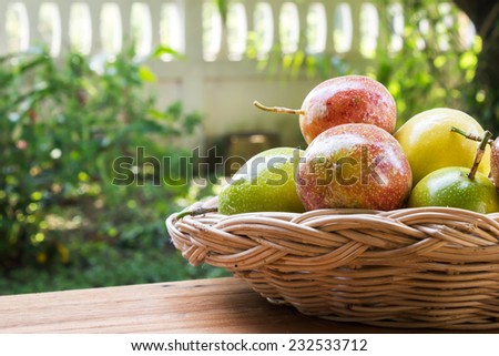 Closeup passion fruit in a basket with garden view.