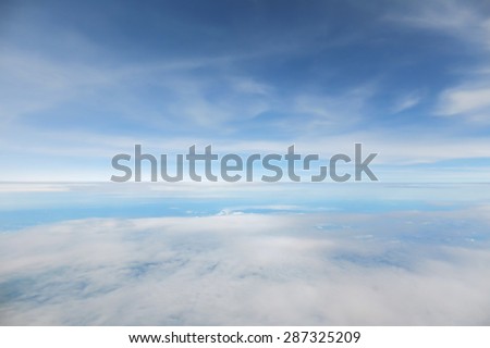 Abstract and blur background of blue sky and cloudy in window view of air plane. Color blue tone.