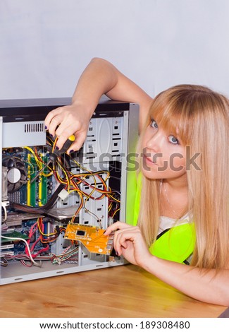 DIY Computer repair by a teenage blond girl, removing and upgrading hardware on desktop computer installing network card etc