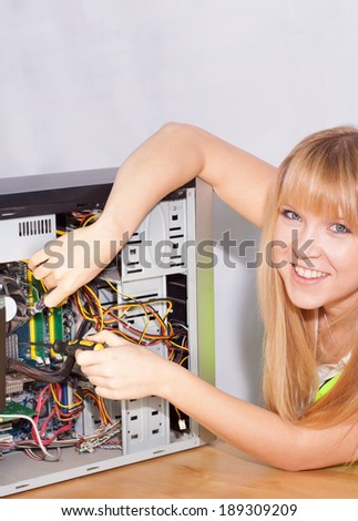 smart young girl repairing a computer