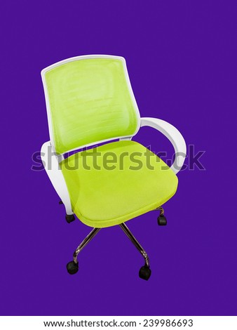 Green office chair on wheels. Isolated object on a violet background.