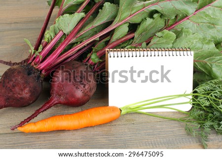 beets and carrot with blank cook book for shopping list , blanck recipe book, copy space