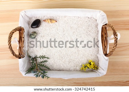 sea salt on the spacing with the elements of nature and note-book on wooden background