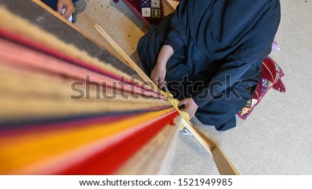 A woman produces traditional Sadu fabric in the Souq Okaz Festival in Taif, Saudi Arabia.