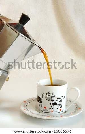 fresh coffee pouring from coffee-maker to white cup