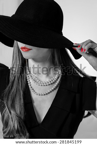 Woman face in black hat. Portrait of elegant woman in black hat. Studio