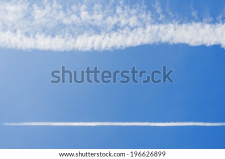 Blue sky with clouds in a straight line.