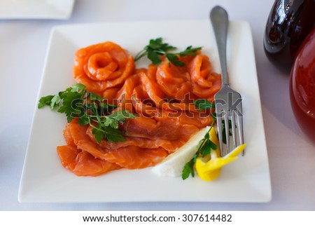 Dish of red fish. Food from the sea fish. Table setting. Cold appetizer. Red salted fresh fish on white dish. Table is set and served food for Banquet and parties. Restaurant kitchen. Service.