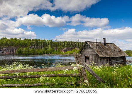 Small old deserted house on a lake side