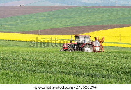 Polski Trambesh April 27: Tractor in the field makes chemical treatment of April 27, 2015, Polski Trambesh, Bulgaria