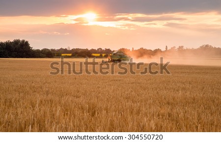 Gorna Oryahovitsa - June 20: Harvesting of grains. Harvester full body truck grain amid strong dramatic sky with the sun on June 20, 2015, Gorna Oryahovitsa, Bulgaria
