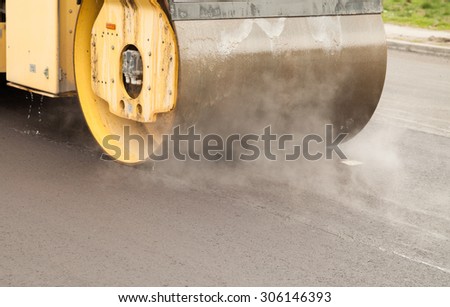 Road roller at road construction site - asphalt paving
