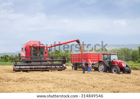 Gorna Oryahovitsa - July 3: Harvest of wheat. Harvester trailer filled with grain. Farmers harvest discuss the background of dramatic sky. On July 3, 2015, Gorna Oryahovitsa, Bulgaria