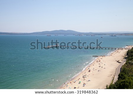 Pictures from the air. Landscape - sea, bay, bridge, beach, garden, distant ships, birds and mountains against the blue sky