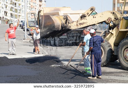 Burgas - August 29: On the job site - laying asphalt on city street of workers and road construction machinery on August 29, 2015 Bourgas, Bulgaria