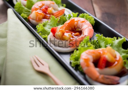 sweet and sour shrimp, prawn cocktail on long square dish and wooden background