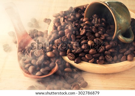 coffee beans on wooden dish with smoke