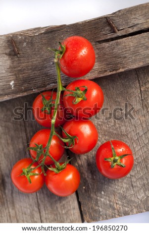 Tomatoes, cooked with herbs for the preservation on the old wooden table