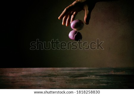 Hand letting go of two onions Stock fotó © 