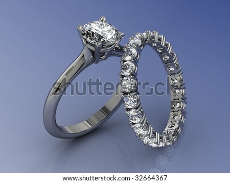 Diamond wedding ring set on blue reflective background