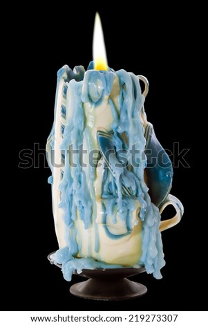 Candle with melted wax collected down the sides on a black background with a clipping path