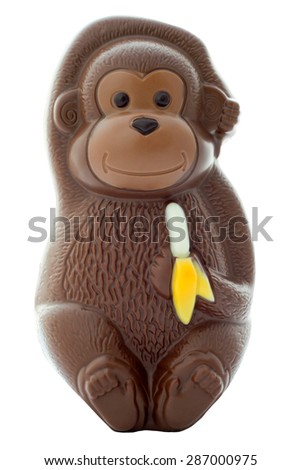 Chocolate monkey figurine holding a banana on an isolated white background with a clipping path