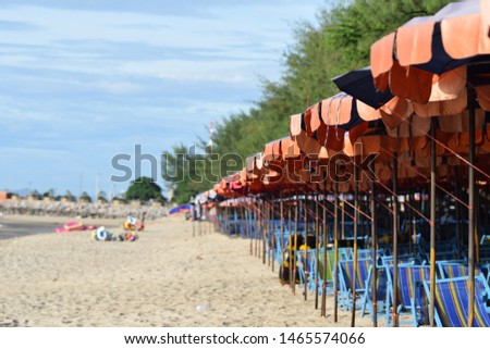 in the row of blue,  orange umbrellas and chair beach on the sea sand Cha Am Thailand back ground is green tree  and blue sky  Photo stock © 