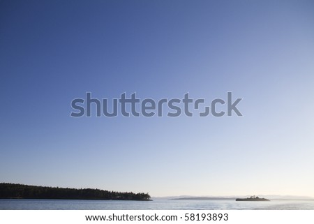 Land stretching out into the ocean with deep blue sky