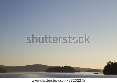 Islands in the ocean at sunset with deep blue sky