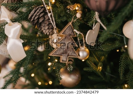 Similar – Image, Stock Photo Christmas tree decorations made of glass in the shape of a star hang in the Christmas tree. In the background you see blurredly even more tree decorations
