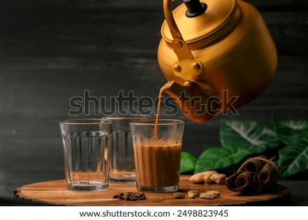 Image, Stock Photo Glass cup with ginger and lemon tea, on a yellow background along with its ingredients.