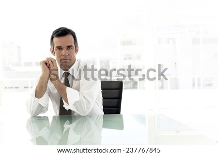 Serious mature businessman in meeting room