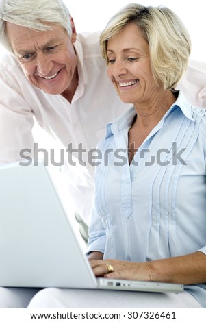 Senior couple using computer together.