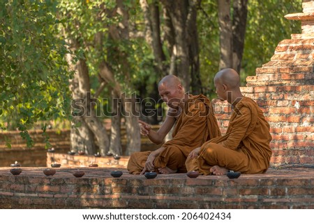 Ayutthaya, Thailand - May 13: A senior monk is teaching a young monk at Wat Mahaeyong (Mahaeyong temple) May 13, 2014.
