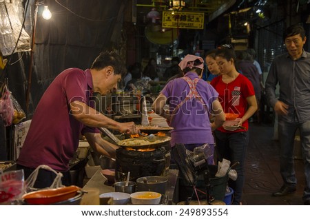Bangkok, Thailand - 31 January 2015 : chinese chef cooking a chinese food at bangkok chinatown on Yaowarat Road, many chinese food vendor around bangkok chinatown.