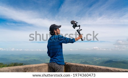 Similar – Image, Stock Photo Man filming a vlog with camera in the city