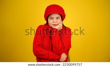 Young Woman feeling cold isolated over yellow background, Shivering due to cold, beautiful Asian Indian women Foto stock © 