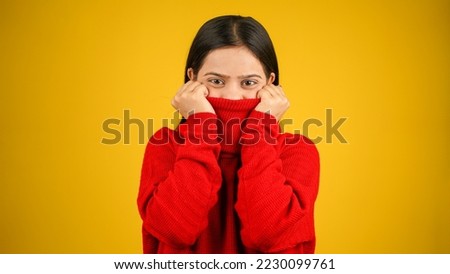 Young Woman feeling cold isolated over yellow background, Shivering due to cold, beautiful Asian Indian women Foto stock © 