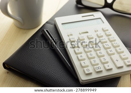 Calculator and Notebook on Desk
