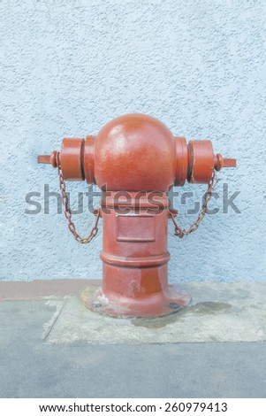 Hydrant used for water injection on stucco wall background